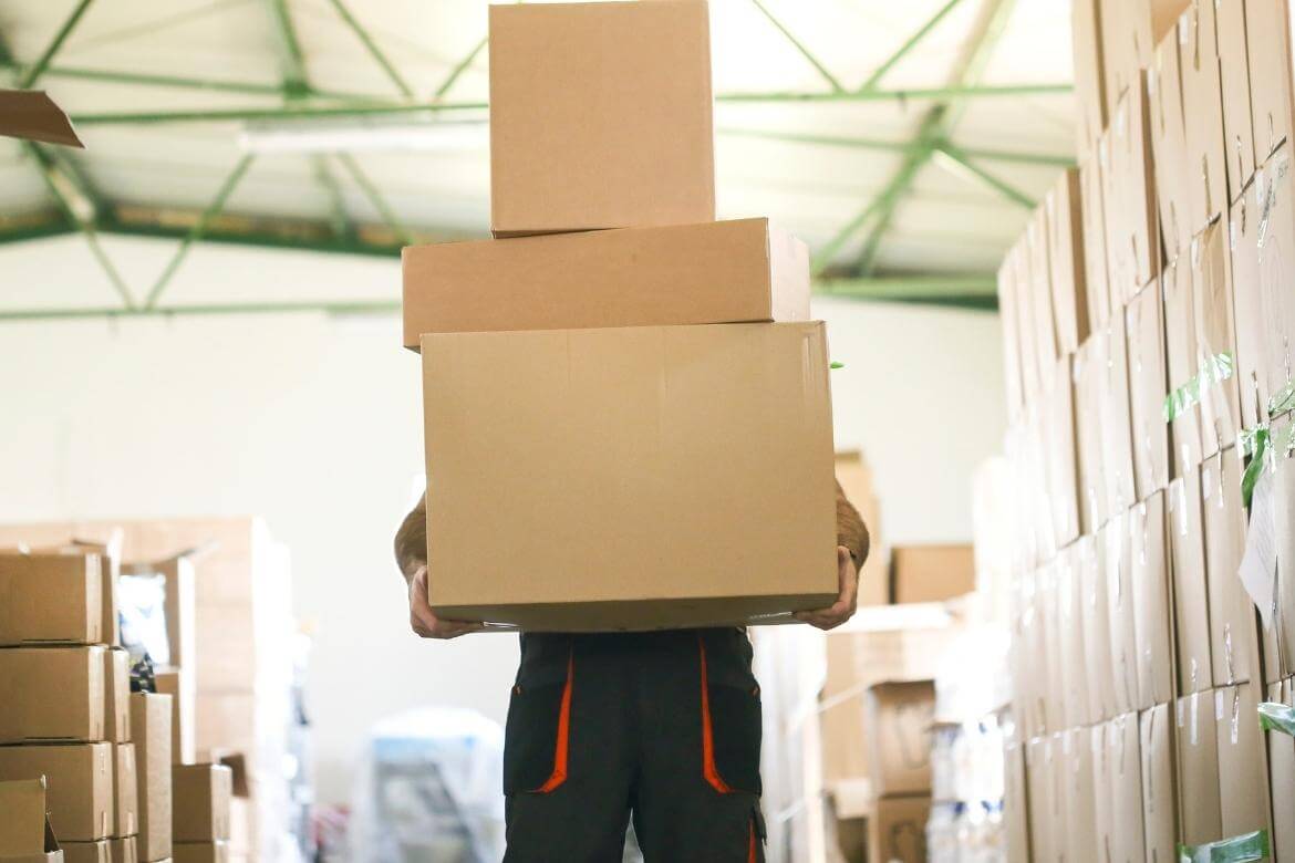 picture of a worker carrying boxes